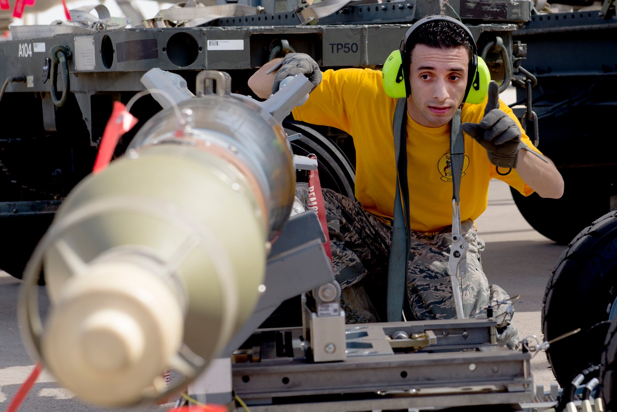 Staff Sgt. Luis Santiago, 61st Aircraft Maintenance Unit weapons load crew lead, prepares an inert bomb for loading during the 2018 1st Quarter Load Crew Competition at Luke Air Force Base, Ariz., April 6. The competition saw load crew teams from the 61st, 62nd, 63rd, 309th, 310th, and 425th AMUs compete to load a mock mission set of ordnance onto F-35 Lightning IIs and F-16 Fighting Falcons in the fastest time. (U.S. Air Force photo by Senior Airman Ridge Shan)