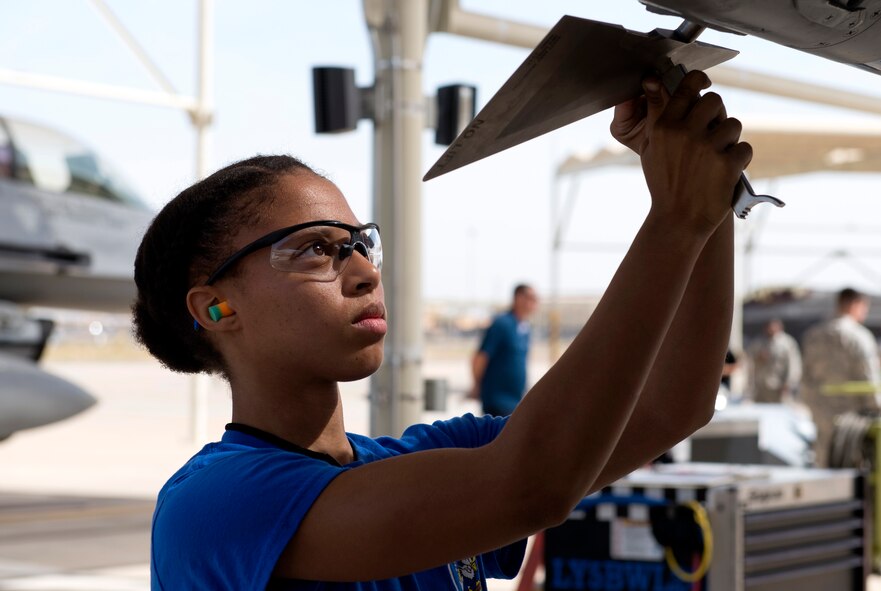 Airman 1st Class Makiah Green, 309th Aircraft Maintenance Unit weapons load crew member, attaches guidance fins onto an inert air-to-air missile during the 2018 1st Quarter Load Crew Competition at Luke Air Force Base, Ariz., April 6. Green and other members of her three-person team divided responsibilities and used high-stress communication techniques to load an aircraft with weapons as quickly and as safely as they could. (U.S. Air Force photo by Senior Airman Ridge Shan)