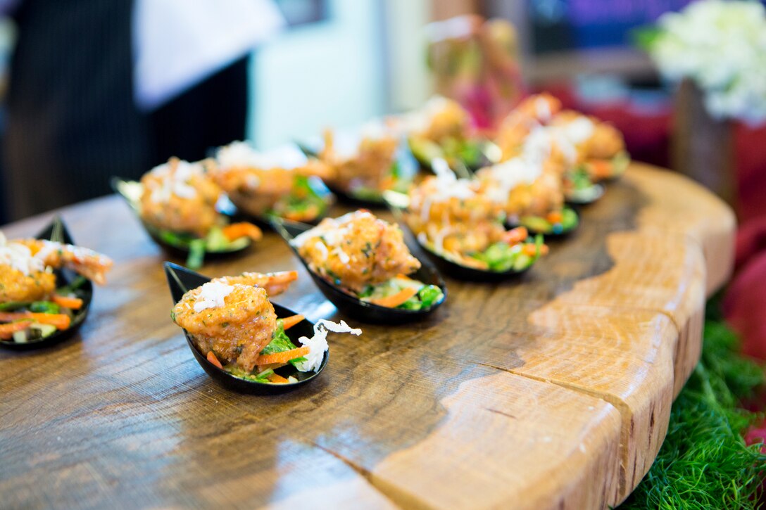 Staff Sgt. Anthony Maietta, an enlisted aide to Lt. Gen. Rex C. McMillian, commander of Marine Forces Reserve and Marine Forces North, leaves on display his sweet and spicy gulf shrimp dish at the annual Best Chef Louisiana competition at the Lakefront Airport Terminal Building, New Orleans, April 10, 2018. Maietta competed in the competition for the opportunity to showcase the Marine Corps in the New Orleans community, himself and one of his signature dishes.