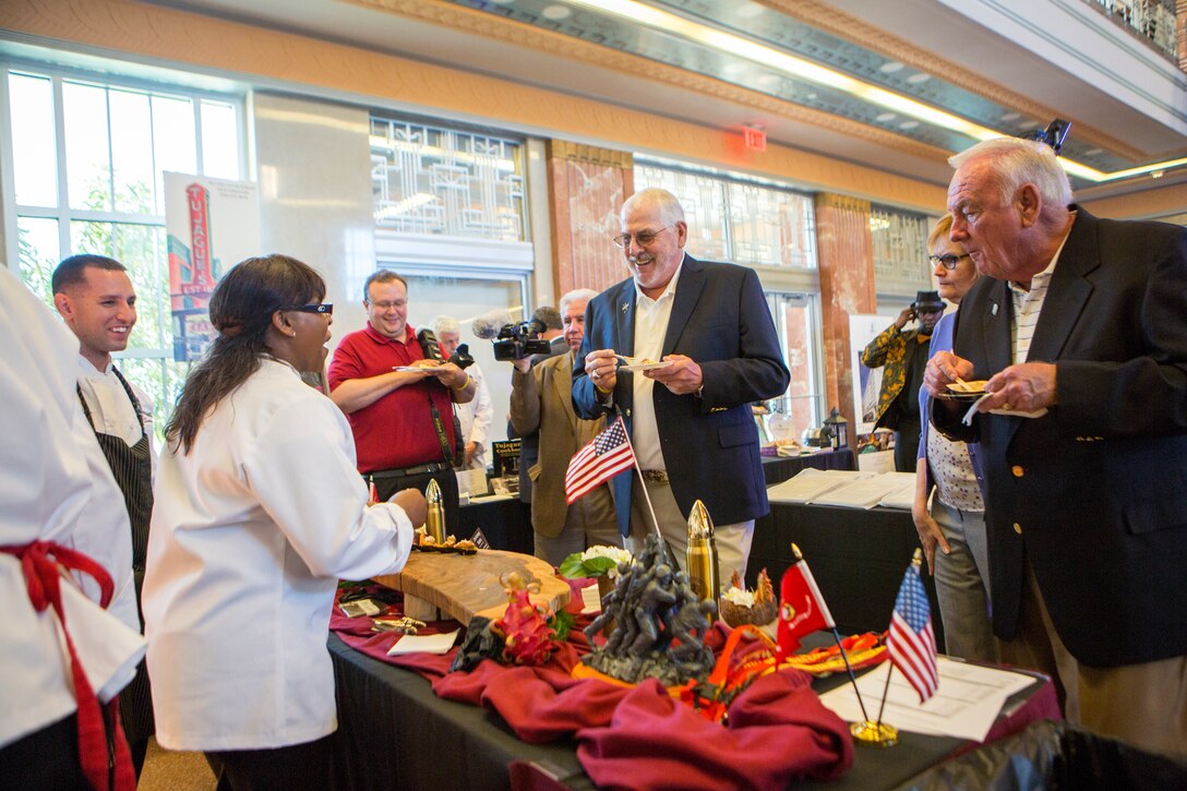 Beverly Boyd, protocol officer for Marine Forces Reserve, talks with attendees of the annual Best Chef Louisiana competition at the Lakefront Airport Terminal Building, New Orleans, April 10, 2018. Maietta competed in the competition for the opportunity to showcase the Marine Corps in the New Orleans community, himself and one of his signature dishes.