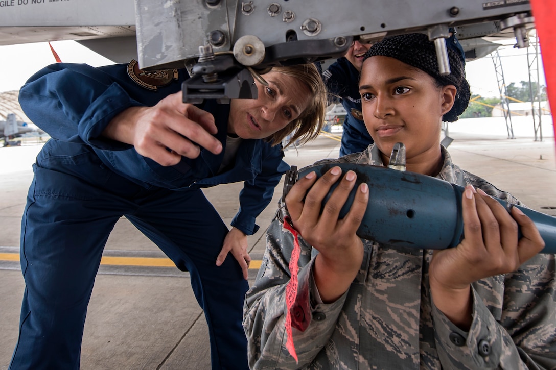 Col. Jennifer Short, left, 23d Wing commander, and Airman 1st Class Kenyah Smith, 74th Aircraft Maintenance unit weapons load crew member, install a training munition onto an A-10C Thunderbolt II during an immersion tour, April 9, 2018, at Moody Air Force Base, Ga. Moody’s leadership toured the 23d Aircraft Maintenance Squadron to get a better understanding of their overall mission, capabilities, and comprehensive duties. (U.S. Air Force photo by Airman Eugene Oliver)