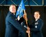 Col. Leo J. Kamphaus, Jr., commander of the 920th Maintenance Group and Maj. Catherine Correa both hold the 920th Maintenance Squadron guidon during the 920th MXS assumption of command ceremony.