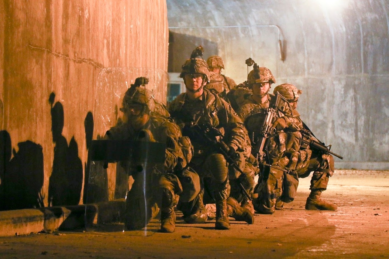 Soldiers rush toward an objective during battle drills.