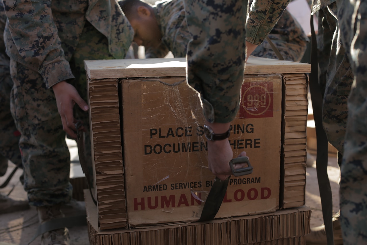 U.S. Marines with 1st Air Delivery Platoon, Landing Support Company, 1st Marine Logistics Group, prepares blood units in preparation of an air delivery at Marine Corps Air Station Yuma, Ariz., March 28, 2018. This training is intended to test the viability of dropping units of blood by air to austere environments when ground delivery is not an option.
