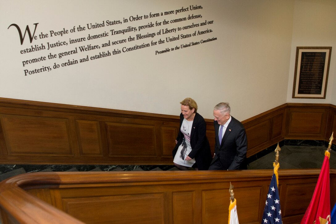 Defense Secretary James N. Mattis walk with the Dutch defense minister up a staircase.