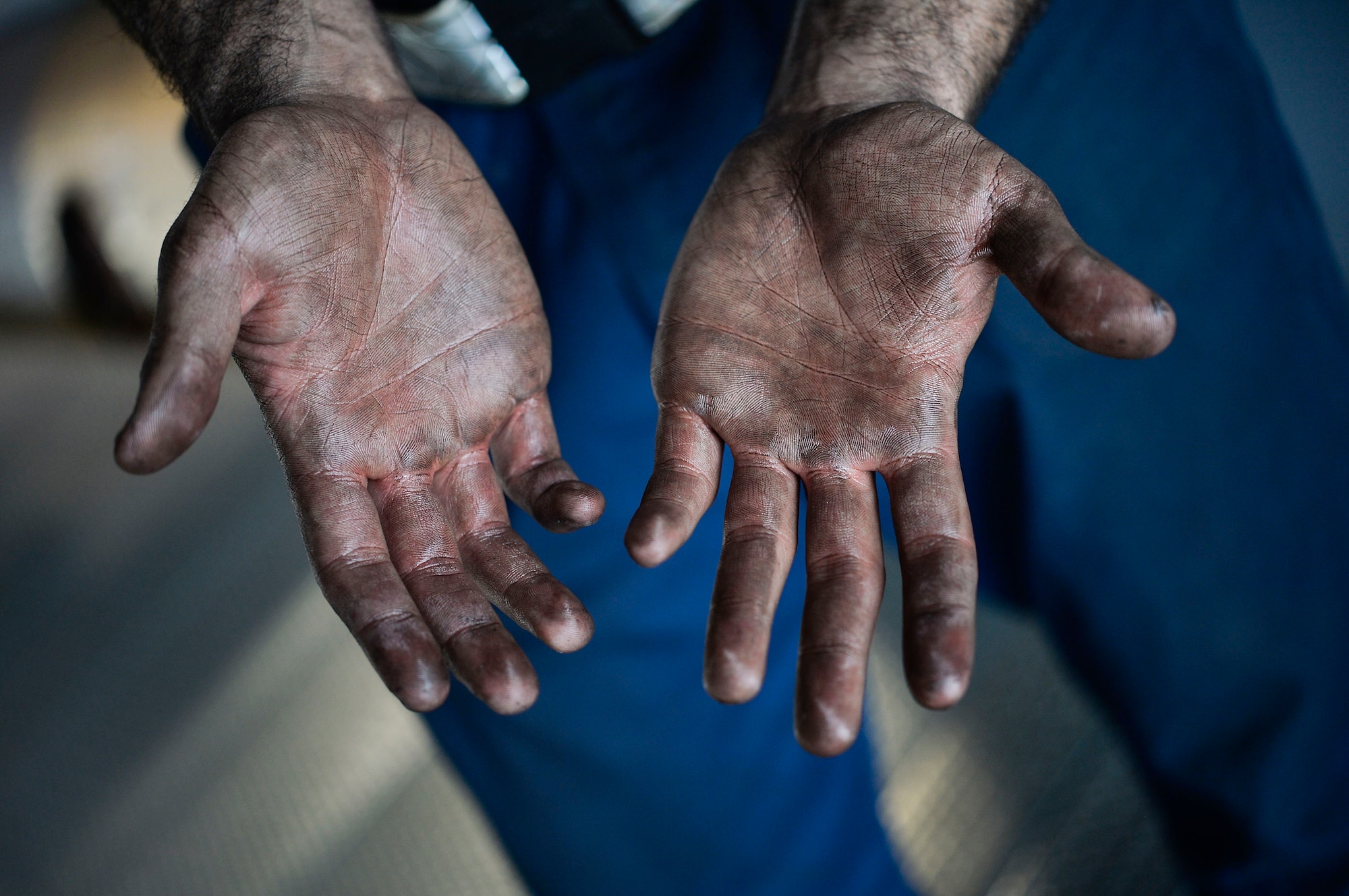 U.S. Air Force Senior Airman Johann Caballero, 86th Maintenance Squadron aerospace propulsion journeyman, shows oil on his hands as the result of conducting maintenance on the engine of a C-130J Super Hercules on Ramstein Air Base, Germany, April 10, 2018. Air Force maintainers are considered mission essential, and are responsible for ensuring the reliability and operational readiness of aircraft. (U.S. Air Force photo by Senior Airman Joshua Magbanua)