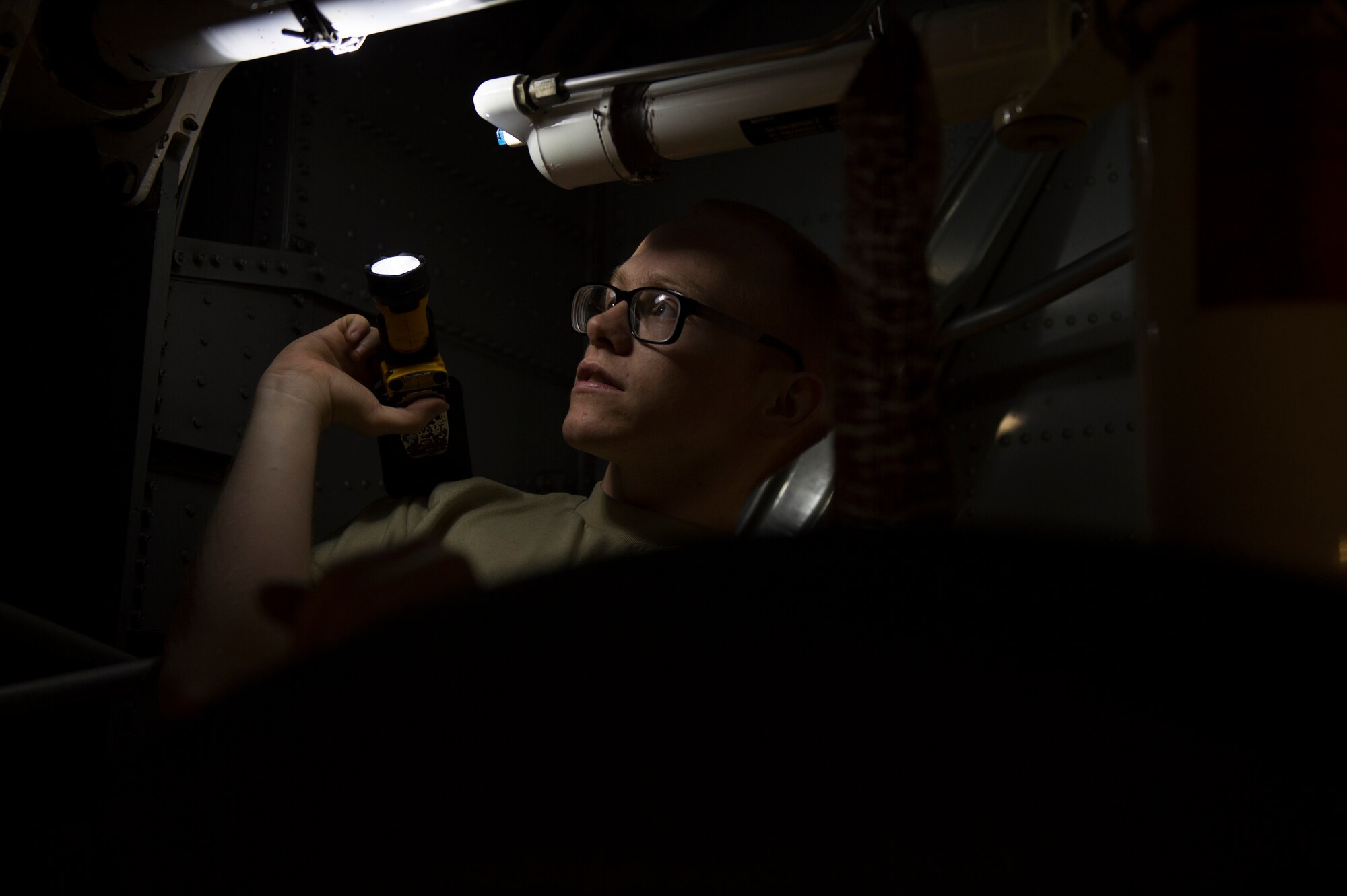 U.S. Air Force Airman 1st Class Alexander McKain, 86th Maintenance Squadron crew chief, inspects the wheel well of a C-130J Super Hercules on Ramstein Air Base, Germany, April 10, 2018. During inspections, Airmen clean and thoroughly search aircraft for any signs of damage. (U.S. Air Force photo by Senior Airman Joshua Magbanua)