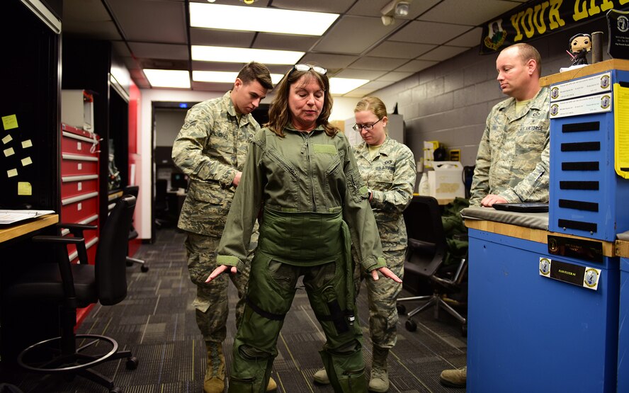 Cathy Felty, Florida’s Bay District schools Teacher of the Year, is fitted for a flightsuit by Airman 1st Class Aaron Cusick, Senior Airman Erin Terry, and Master Sgt. Andrew Peery, from the 325th Operations Support Squadron, prior to a T-38 Talon familiarization flight at Tyndall Air Force Base, Fla., April 9, 2018. Felty was flown in a T-38 to better familiarize her with Tyndall’s mission and the base’s impact on the local, state, and national arenas. She was flown after undergoing several safety briefings, medical screenings, and a mission brief. (U.S. Air Force photo by Airman 1st Class Isaiah J. Soliz/Released)