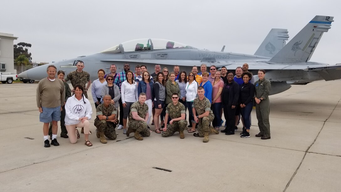 The Marines and educators of Marine Corps Recruiting Station Milwaukee stand in front of an F/A-18D Hornet during the Educator’s Workshop while touring Marine Corps Air Station Miramar, California April 4, 2018.The educators were given a tour of MCAS Miramar so that they could learn about what the Marine Corps offered Marines in the operating forces after their initial training. The Educators' Workshop is an annual event where educators from across the Western Recruiting Region got to Marine Corps San Diego and learn about what it takes to make Marines. (U.S. Marine Corps photo by Sgt. Nicholas Ranum/Released)