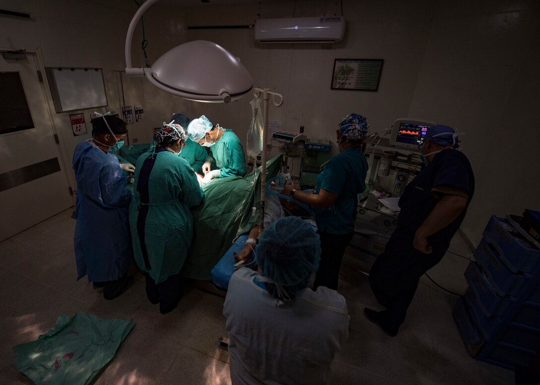 Doctors perform surgery on a patient in Guatemala.