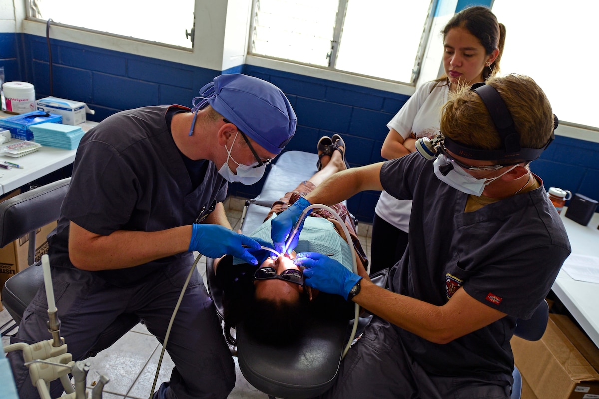 Military dentists treat a patient in Guatemala.