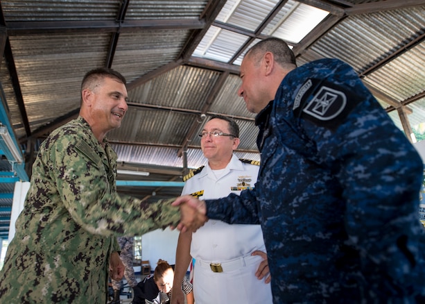 Military leaders shake hands.