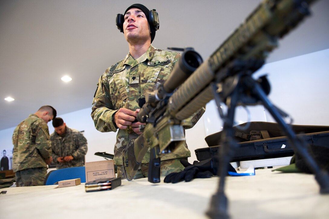 A soldier loads ammunition into magazines.