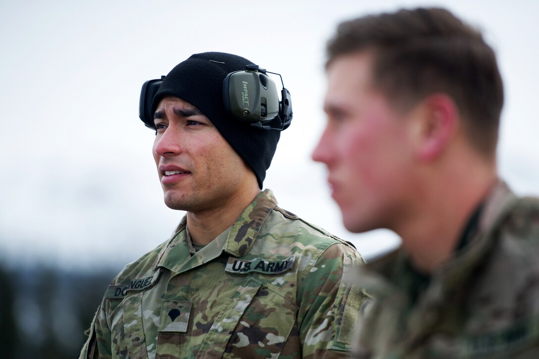 A soldier listens to a rifle safety briefing.