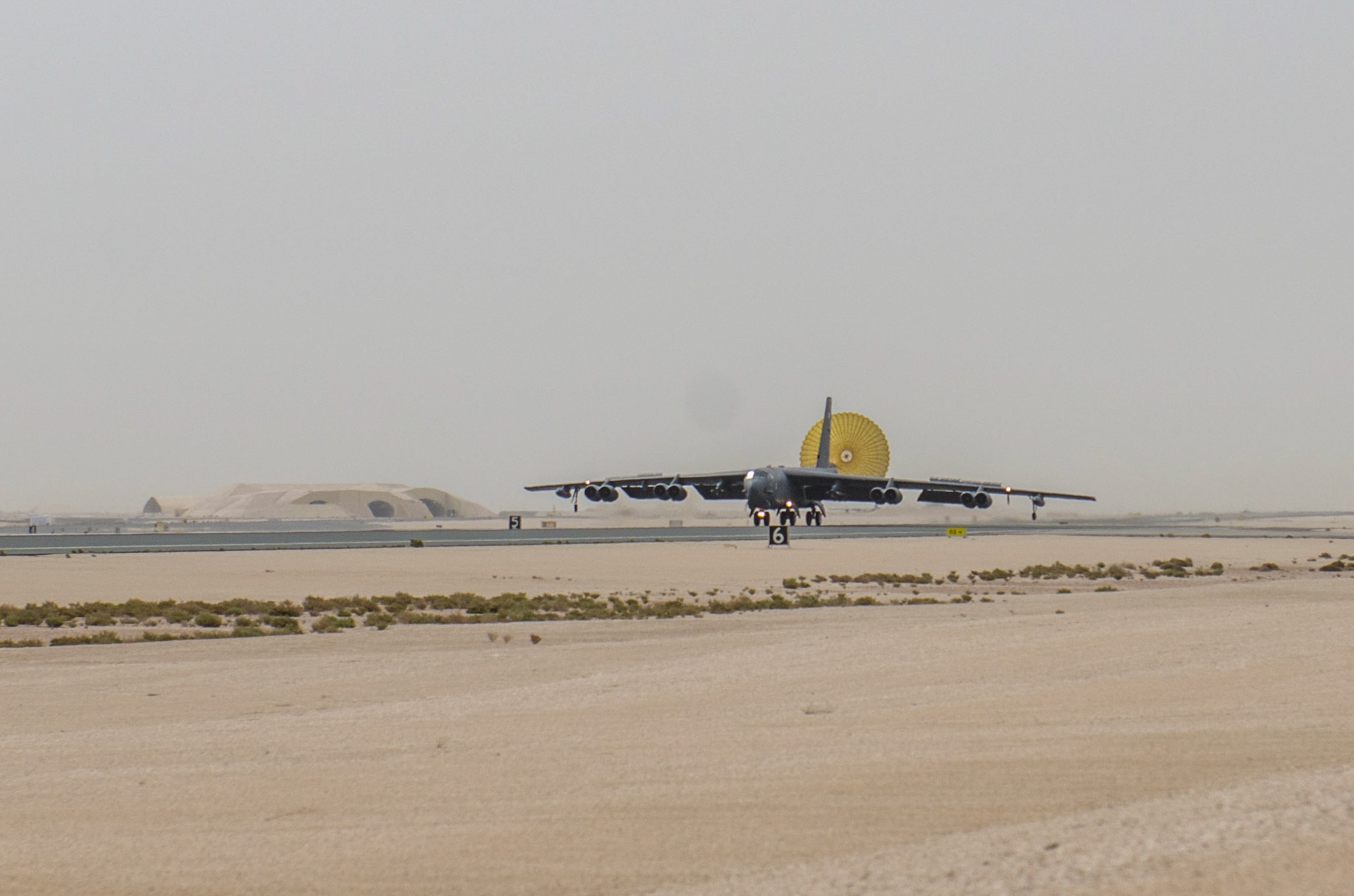 A B-52 Stratofortress aircraft assigned to the 69th Expeditionary Bomb Squadron lands at Al Udeid Air Base, Qatar, April 8, 2018, signifying the completion of its last sortie here before turning over the bomber mission to the newly arrived B-1B Lancer.  Since its arrival in 2016, the BUFF flew more than 1,800 sorties and employed nearly 12,000 weapons against ISIS and Taliban targets. (U.S. Air Force photo by Staff Sgt. Patrick Evenson)