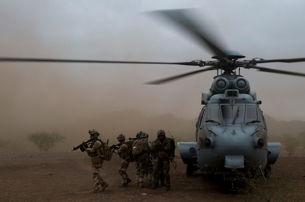 Air Force pararescuemen assigned to 48th Rescue Squadron and French air commandos provide cover after moving simulated patient into Eurocopter EC-725 for aerial transport during personnel recovery scenario in southern Arizona, November 7, 2017, as part of Angel Thunder (U.S. Air Force/Andrew Lee)