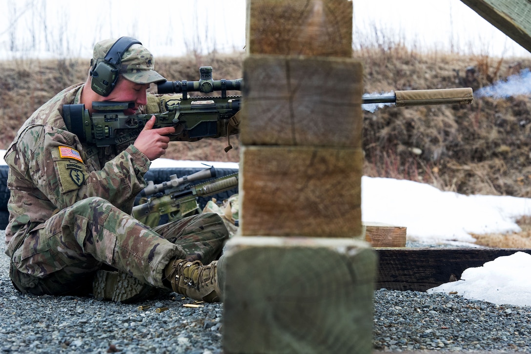 A soldier fires a sniper rifle.