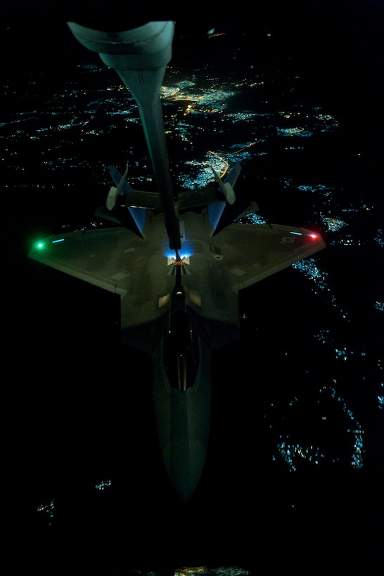 Air Force KC-10 Extender aircraft refuels F-22 Raptor aircraft over undisclosed location, September 26, 2014, before strike operations in Syria (DOD/Russ Scalf)