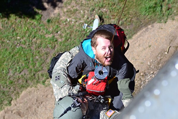 U.S. Army Staff Sgt. Jose Pantoja, a flight medic with Charlie Company, 2nd General Support Aviation Battalion, 4th Aviation Regiment, 4th Combat Aviation Brigade, 4th Infantry Division, carries Mike Daniels, right, an evacuee, up a hoist onto a UH-60 Black Hawk helicopter during a flood rescue and recovery operations in Boulder, Colo., Sept. 16, 2013. Colorado and Wyoming National Guard units were activated to provide assistance to people affected by massive flooding along Colorado's Front Range.