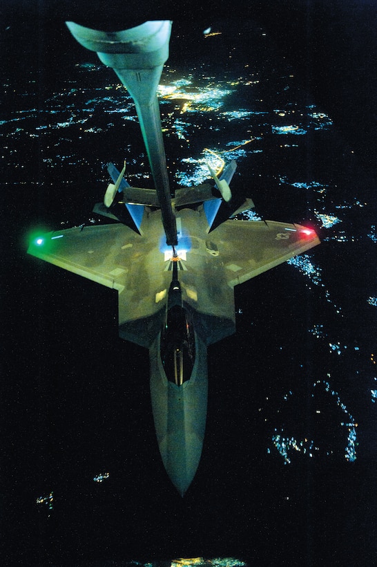 Air Force KC-10 Extender aircraft refuels F-22 Raptor aircraft over undisclosed location, September 26, 2014, before strike operations in Syria (DOD/Russ Scalf)