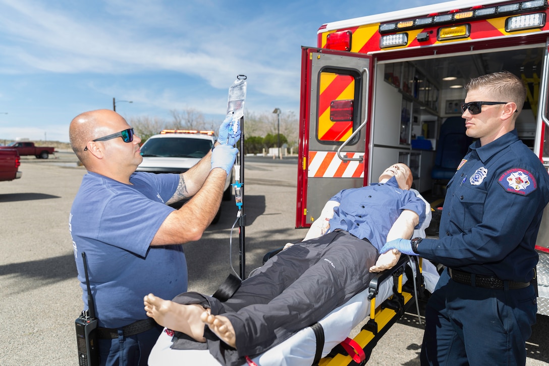 Carlos Torres, firefighter-paramedic, and Kevin Craven, firefighter-emergency medical technician, both with Fire and Emergency Services, demonstrate the use of a ketamine mixture for pain management on potential patients for an upcoming test trial aboard Marine Corps Logistics Base Barstow, Calif., April 5.