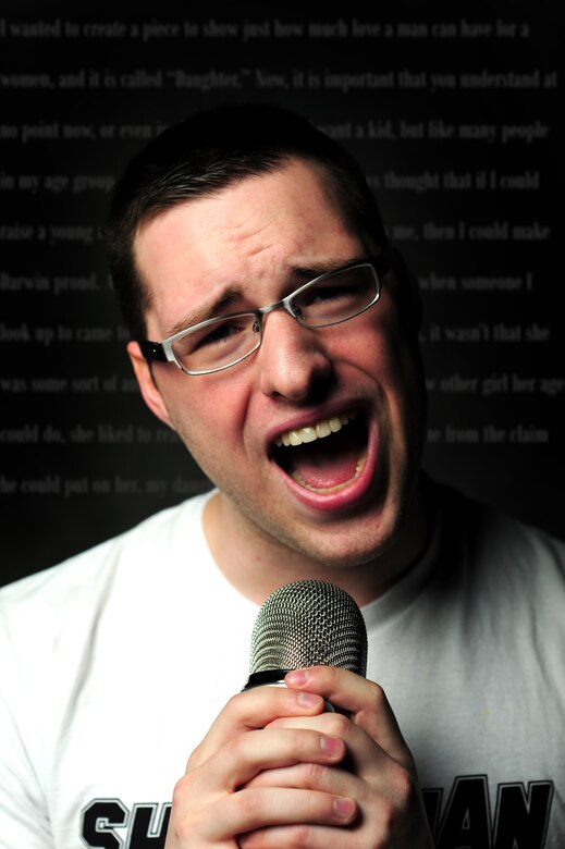 U.S. Air Force Airman 1st Class John Cone writes and reads one of his slam poetry pieces.