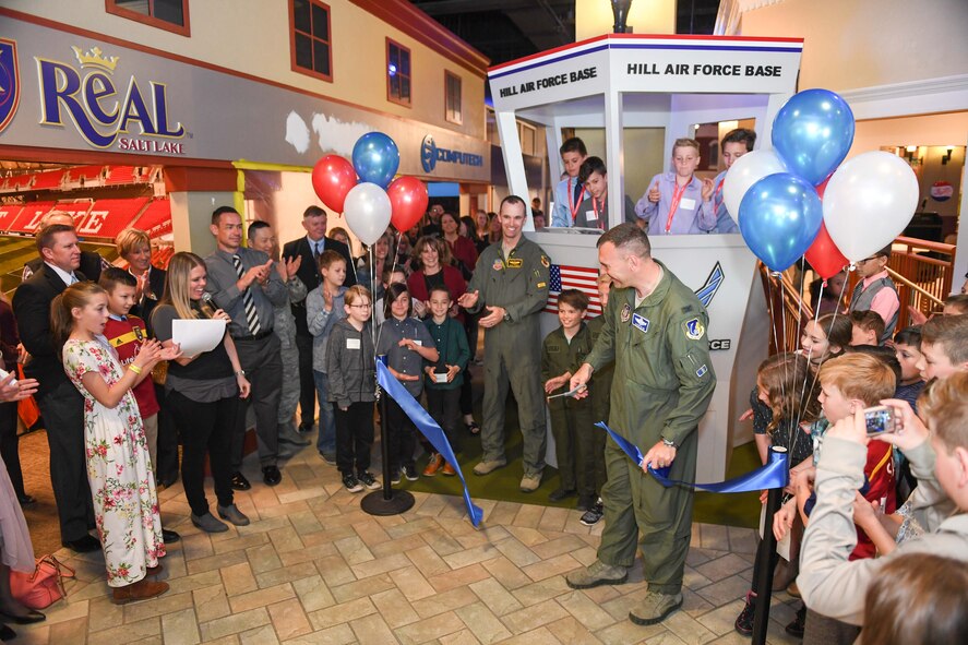 Col. Aaron Blum, 75th Air Base Wing, with Maj. Shayne Carroll, 4th Figher Squadron, cut the ceremonial ribbon during Junior Achievement City's grand opening of their model air traffic control tower April 10, 2018, in Salt Lake City. The tower was built courtesy of Hill Air Force Base. The JA City is an interactive learning environment where students learn about real-life careers. (U.S. Air Force photo by Cynthia Griggs)