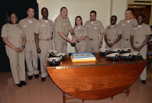 NHCC Command Master Chief Anthony Petrone, left, and Chief Petty Officer Jami Tankiss, center, cut the cake during a ceremony March 30 at NHCC celebrating the 125th birthday of the Navy’s Chief Petty Officer rank. Appearing in the photo, from left to right: Senior Chief Petty Officer Jacqueline Colbourne, Senior Chief Petty Officer Greg Lassiter, Chief Petty Officer Anthony Johnson, Petrone, Tankiss, Chief Petty Officer Freddy Mejia, Chief Petty Officer Ashley Cooper, Chief Petty Officer Sean Reeves and Chief Petty Officer Capricia Williams.