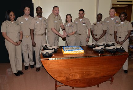 NHCC Command Master Chief Anthony Petrone, left, and Chief Petty Officer Jami Tankiss, center, cut the cake during a ceremony March 30 at NHCC celebrating the 125th birthday of the Navy’s Chief Petty Officer rank. Appearing in the photo, from left to right: Senior Chief Petty Officer Jacqueline Colbourne, Senior Chief Petty Officer Greg Lassiter, Chief Petty Officer Anthony Johnson, Petrone, Tankiss, Chief Petty Officer Freddy Mejia, Chief Petty Officer Ashley Cooper, Chief Petty Officer Sean Reeves and Chief Petty Officer Capricia Williams.