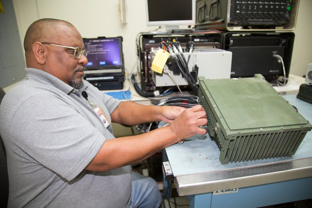 Miguel Sanchez, Optics Lab journeyman, tests a modified computer unit from a M777 Howitzer to ensure that the SBC card is functioning at the Optics Lab, Production Plant Barstow, Marine Depot Maintenance Command, on the Yermo Annex aboard Marine Corps Logistics Base Barstow, Calif., March 28. The units can short out and the parts are no longer made so the artisans install modifications before installing them back onto the equipment.