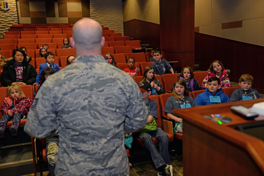 Tech. Sgt. Taylor Evans, a 28th Security Forces Squadron unit training instructor, encourages children to stay resilient during a kids deployment line at Ellsworth Air Force Base, S.D., April 7, 2018.  The kids deployment line is an annual event hosted at Ellsworth AFB to celebrate the Month of the Military Child. (U.S. Air Force photo by Airman 1st Class Nicolas Z. Erwin)