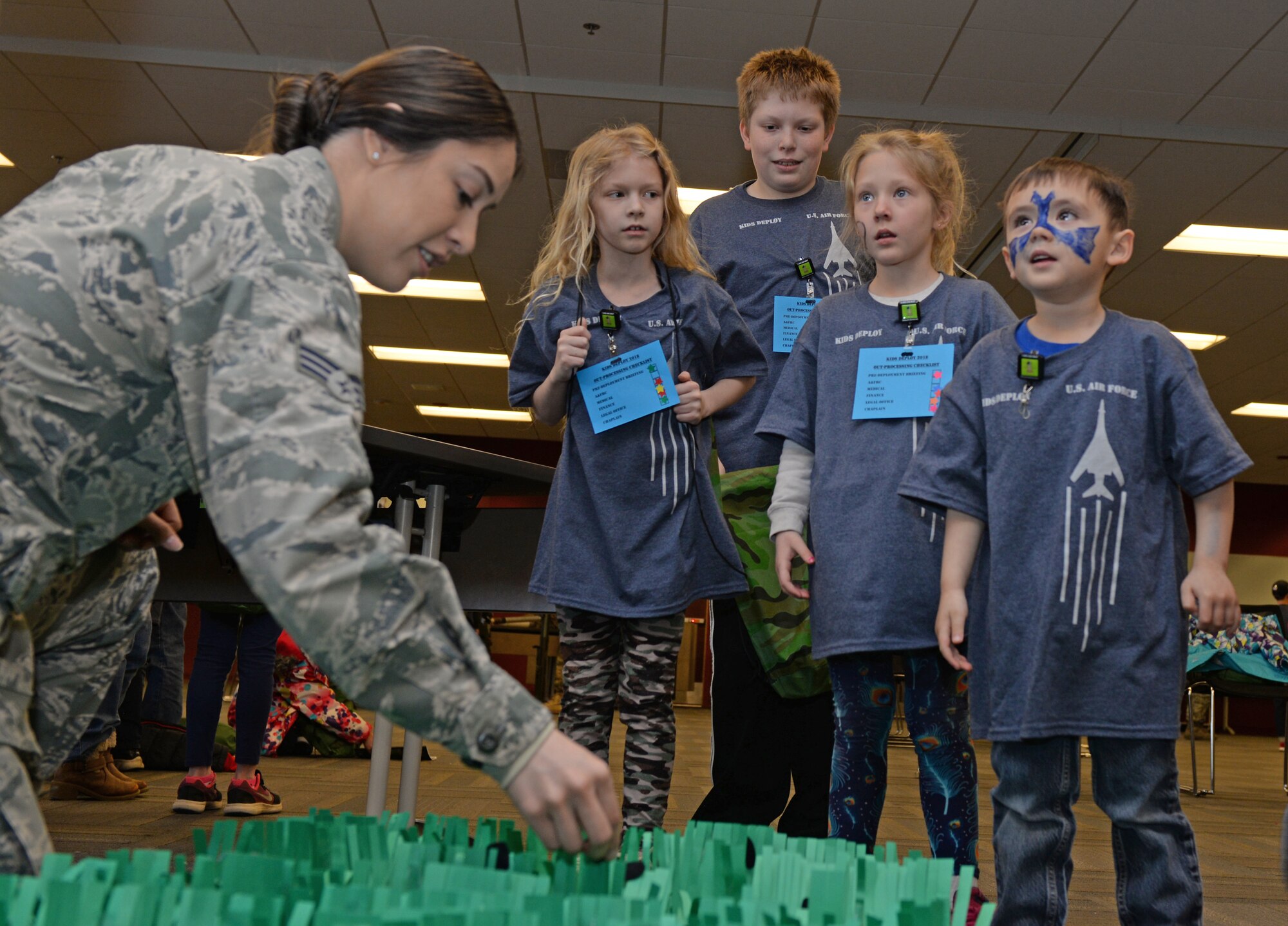 Children are given instructions for a game during a kids deployment line at Ellsworth Air Force Base, S.D., April 7, 2018.  One hundred children participated in the deployment line celebrating Month of the Military Child. (U.S. Air Force photo by Airman 1st Class Nicolas Z. Erwin)