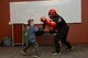 A child spars with a 28th Security Forces team member during a kids deployment line at Ellsworth Air Force Base, S.D., April 7, 2018. During the line, children were given the opportunity to experience what it feels like to prepare for a deployment. (U.S. Air Force photo by Airman 1st Class Nicolas Z. Erwin)