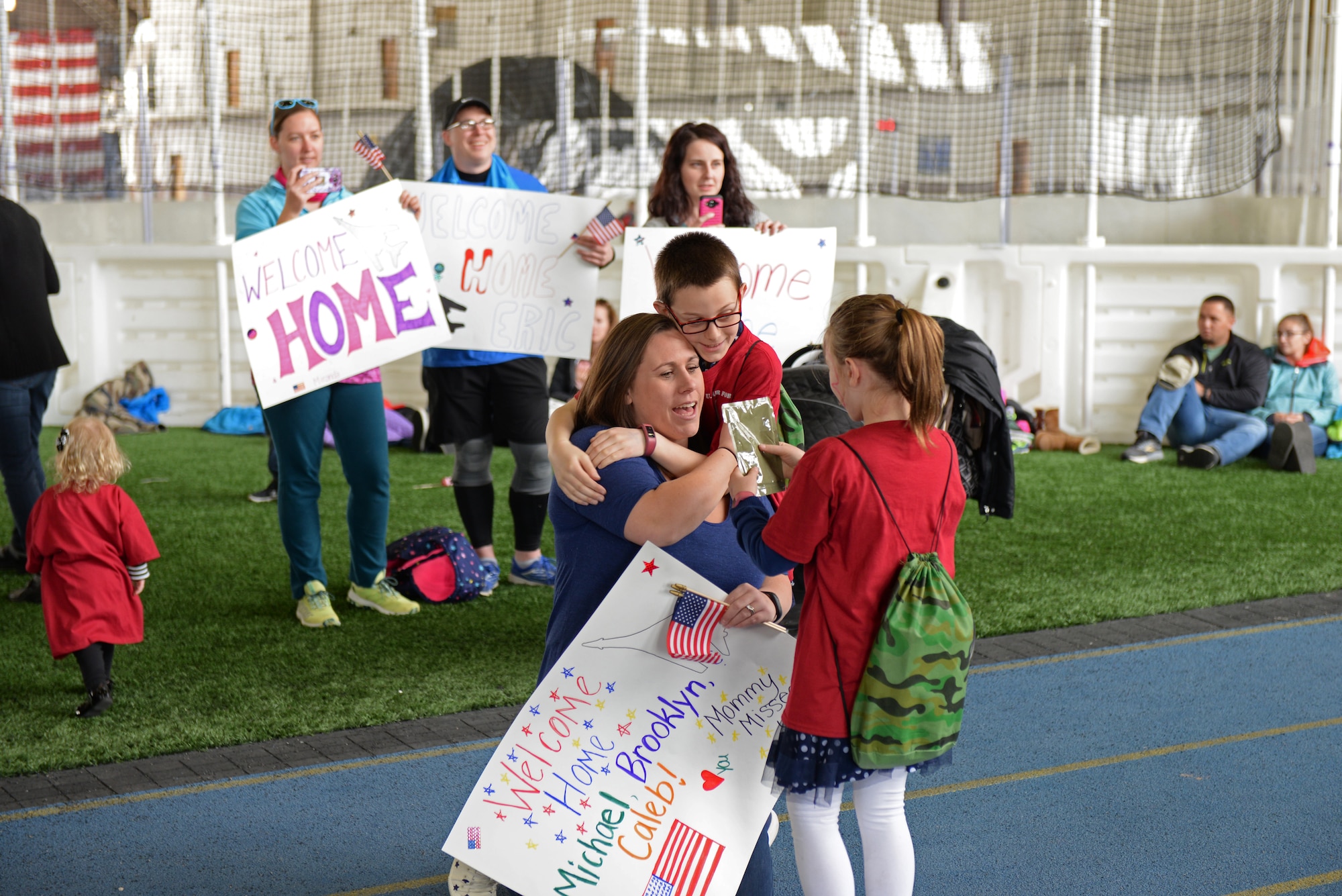 A family is reunited after a kids deployment line at Ellsworth Air Force Base, S.D., April 7, 2018. This Month of the Military Child event was coordinated by the Airman & Family Readiness Center, Youth Center and Child Development Center. (U.S. Air Force photo by Airman 1st Class Nicolas Z. Erwin)