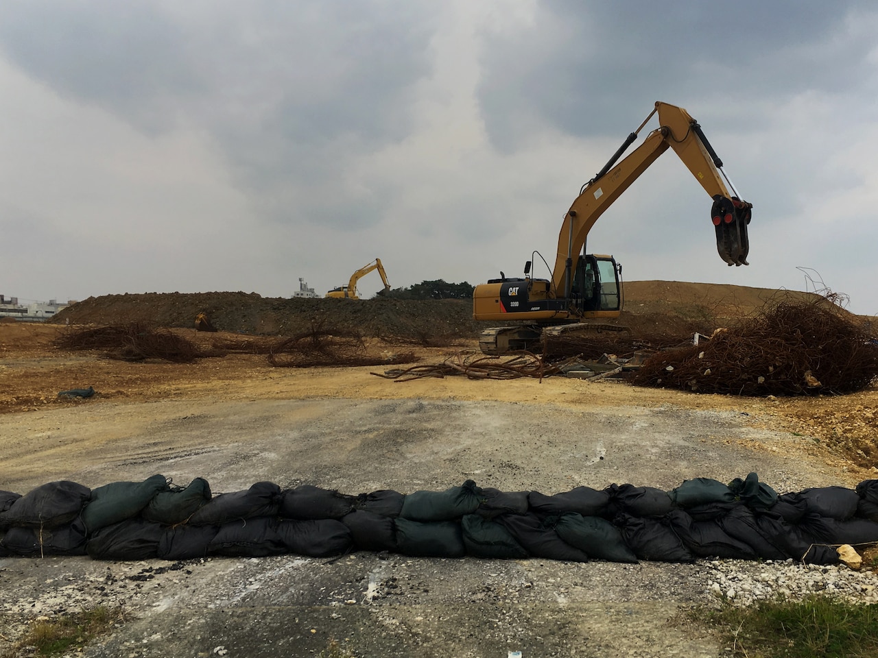 A Japanese construction worker paves the foundation for new base housing at Camp Foster, Japan.