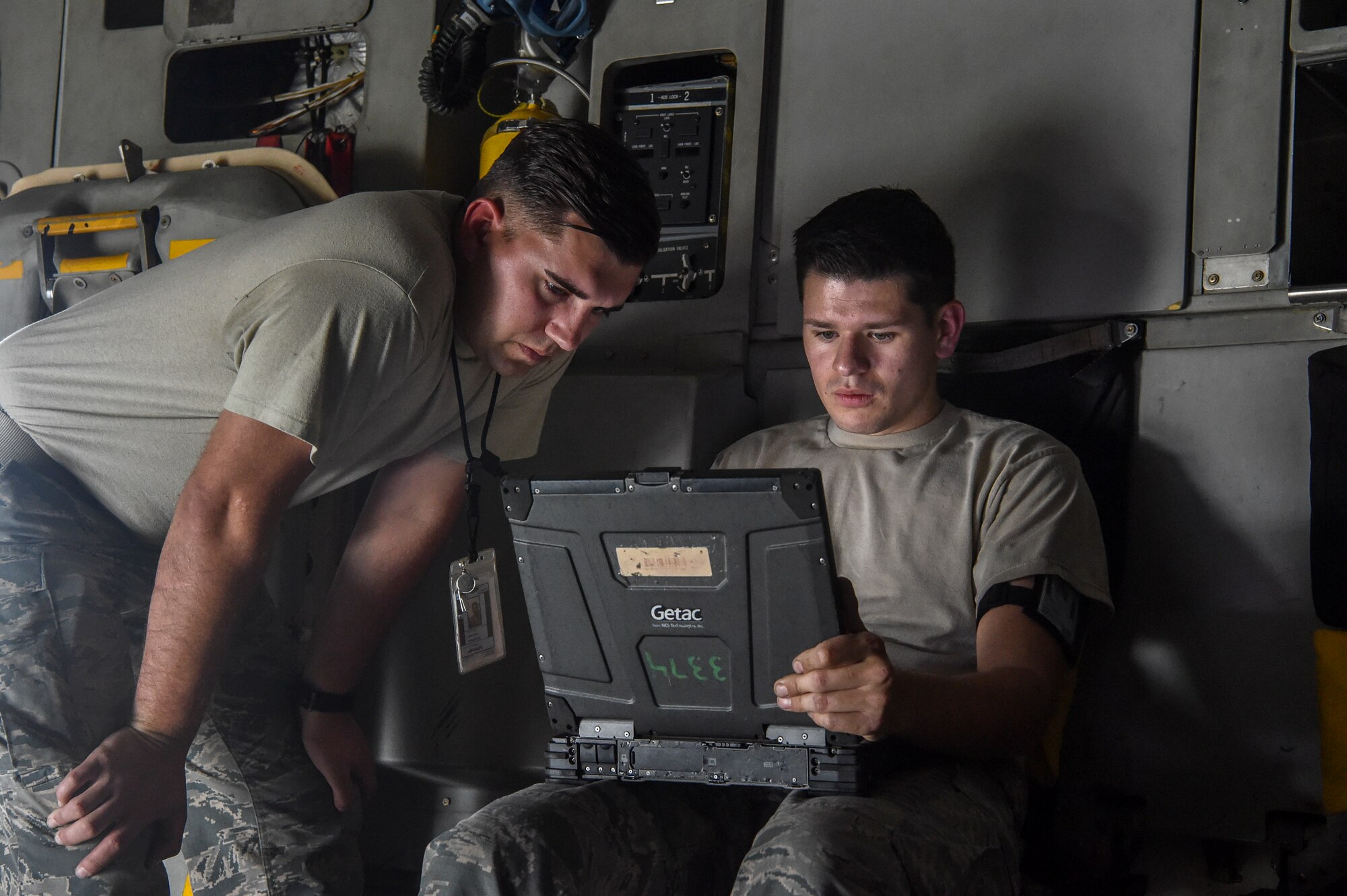 Senior Airman Ethan Fite ,left, and Airman 1st Class Jerry Marin ,right, 437th Aircraft Maintenance Squadron crew chiefs, log parts during an aircraft inspection at Joint Base Charleston, S.C., April 4, 2018.