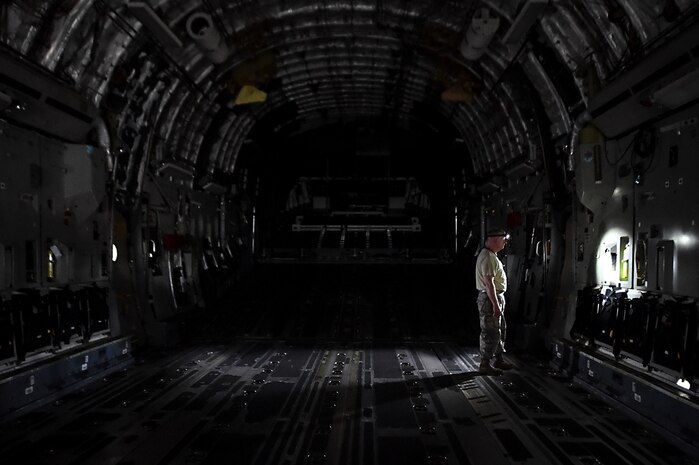 Tech. Sgt. Shannon Garris, 145th Air Wing quality assurance inspector, examines a C-17 Globemaster III prior to transferring to the Charlotte Air National Guard, N.C., at Joint Base Charleston, S.C., April 4, 2018.