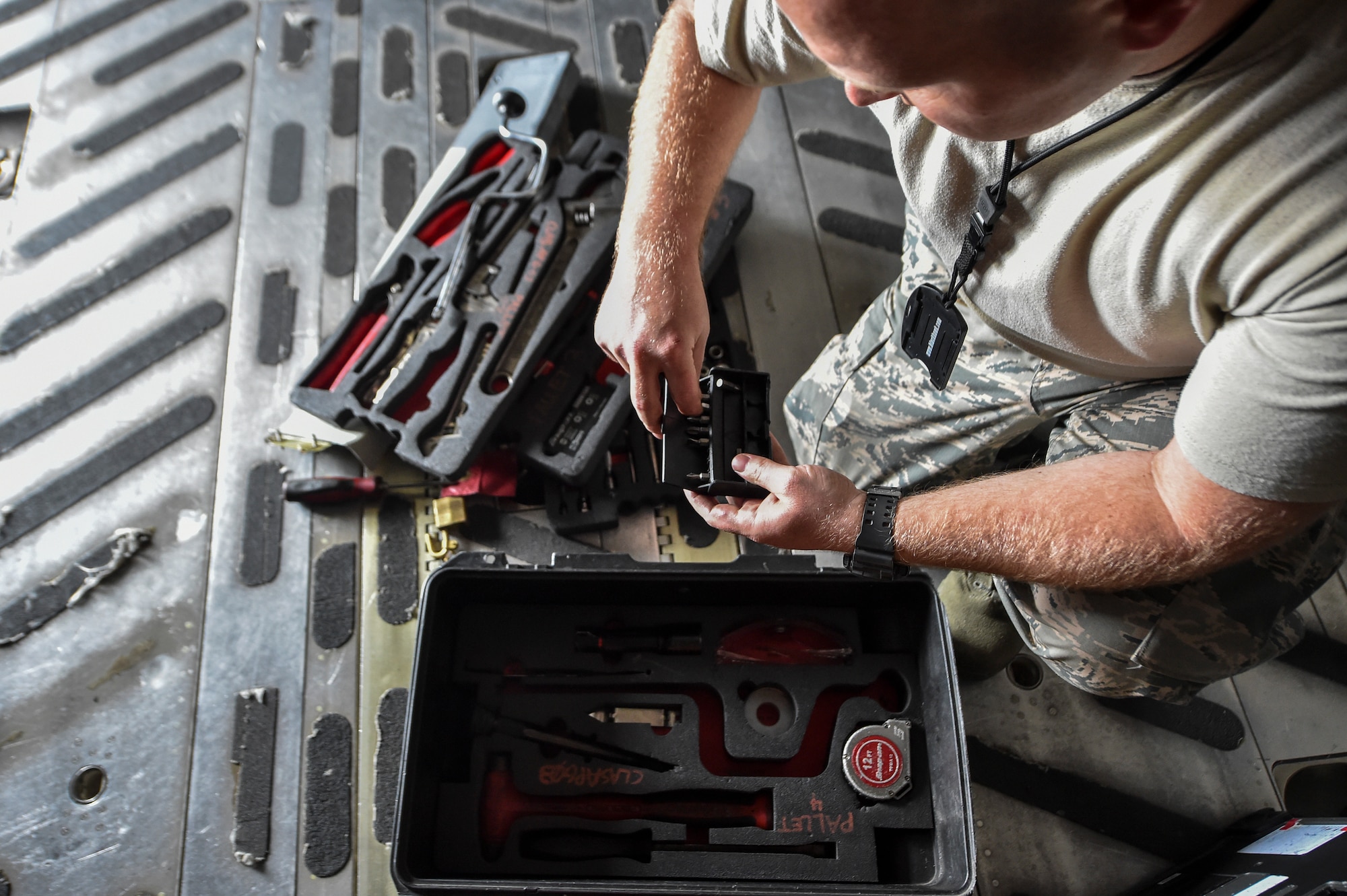 Staff Sgt. Travis Ryan, 437th Aircraft Maintenance Squadron scheduled maintenance NCO in charge, chooses a tool during a C-17 Globemaster III inspection at Joint Base Charleston, S.C., April 4, 2018.