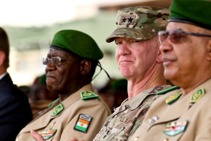 An American general and other military members sit together.