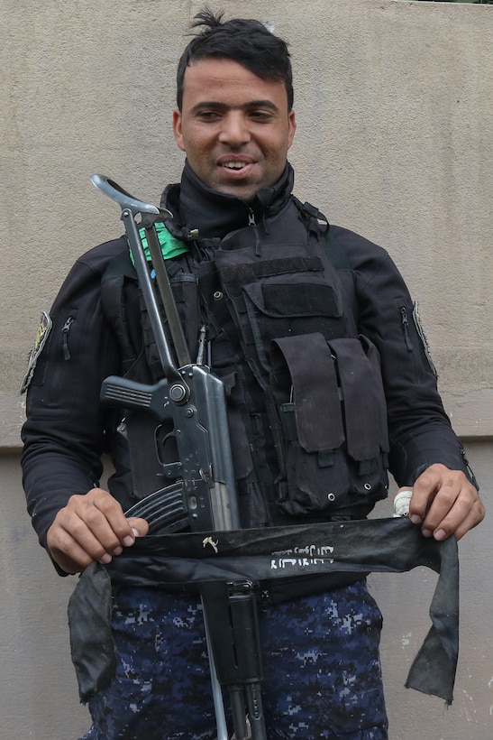 Member of Iraqi federal police holds discarded ISIS headband during offensive to liberate and secure West Mosul, March 2, 2017 (U.S. Army/Jason Hull)