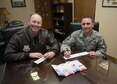 Col. David Berg, 55th Wing vice commander and Chief Master Sgt. Brian Kruzelnick, 55th Wing command chief, fill out a form in support of the Air Force Assistance Fund at the 55th Wing headquarters on Offutt Air Force Base, Neb., March 30, 2018.