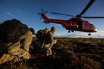 Army Explosive Ordnance Disposal Technicians look on as Icelandic coastguard helicopter takes off from field in Iceland during exercise Northern
Challenge 2017 (NATO/Laurence Cameron)