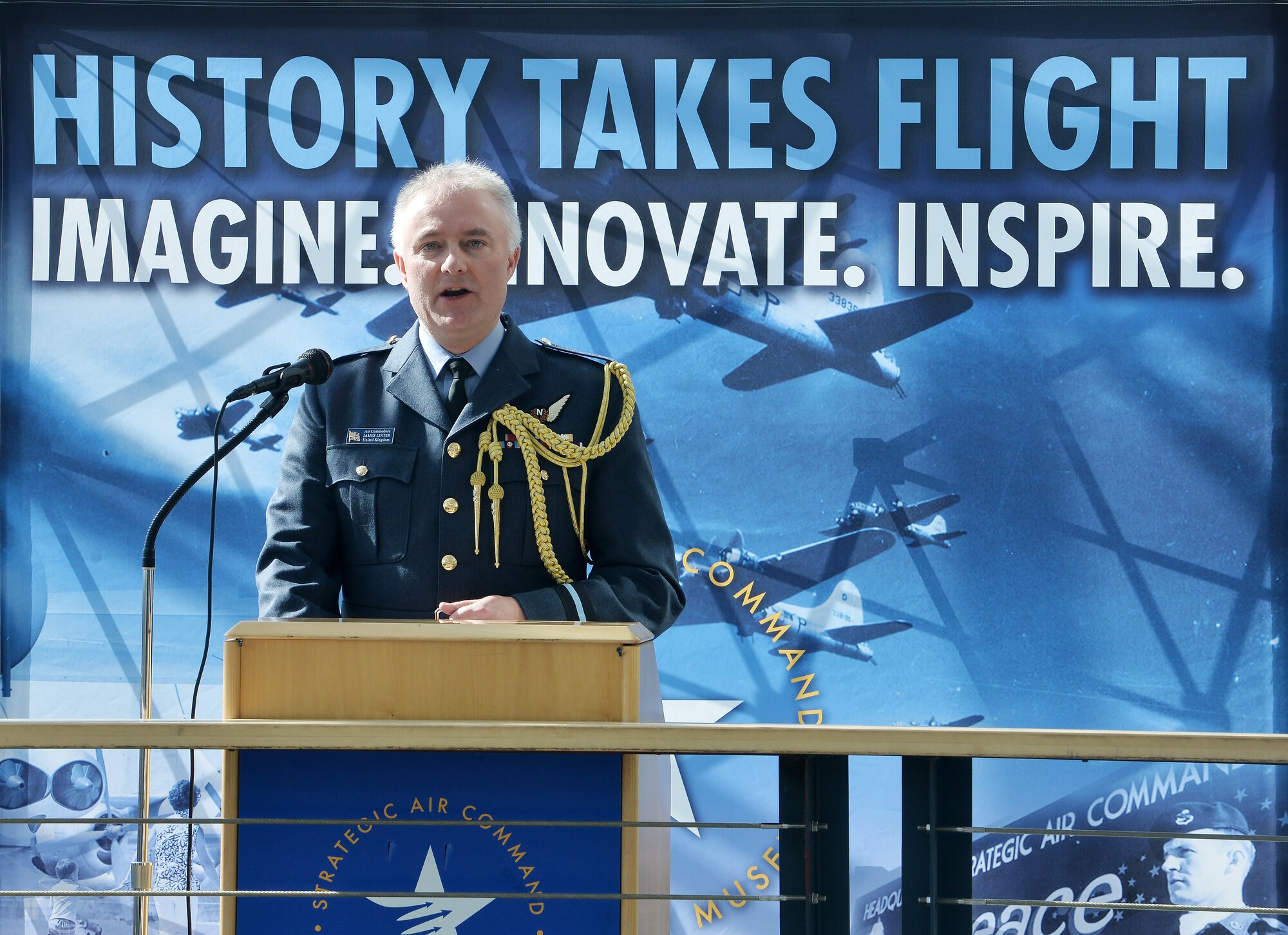 Royal Air Force Air Commodore James Linter, Air Attaché, speaks on the relationship with the RAF and U.S. Air Force has grown over the years during the War and Peace event commemorating the 70th anniversary of the U.S. Air Force and 100th anniversary of the U.K. Royal Air Force ceremony on April 7, 2018 inside the Strategic Air and Space Museum in Ashland, Nebraska.