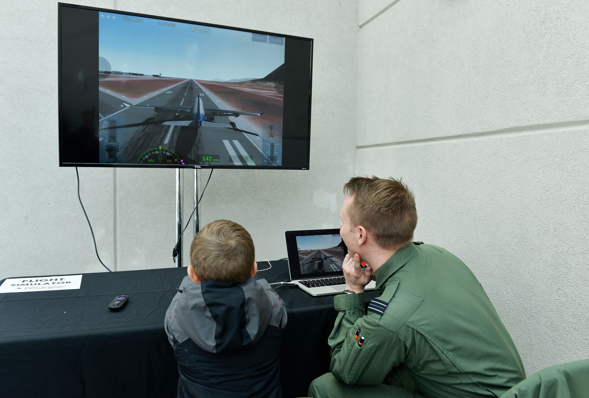 Jackson Saunders, the grandson of Retired Air Force Col. David Balsillie, receives guidance from Royal Air Force Flight Lieutenant Elliott, with the 338th Combat Training Squadron, during the War and Peace event commemorating the 70th anniversary of the U.S. Air Force and 100th anniversary of the U.K. Royal Air Force ceremony on April 7, 2018 inside the Strategic Air and Space Museum in Ashland, Nebraska.