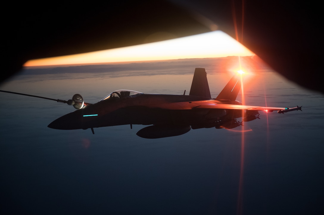 KC-135 Stratotanker assigned to 340th Expeditionary Air Refueling Squadron, Al Udeid Air Base, Qatar, refuels Navy F/A-18E/F Super Hornet assigned to
USS Theodore Roosevelt, performing precision airstrikes against six Taliban narcotic targets in Helmand Province, Afghanistan, December 7, 2017 (U.S. Air Force/Jeff Parkinson)