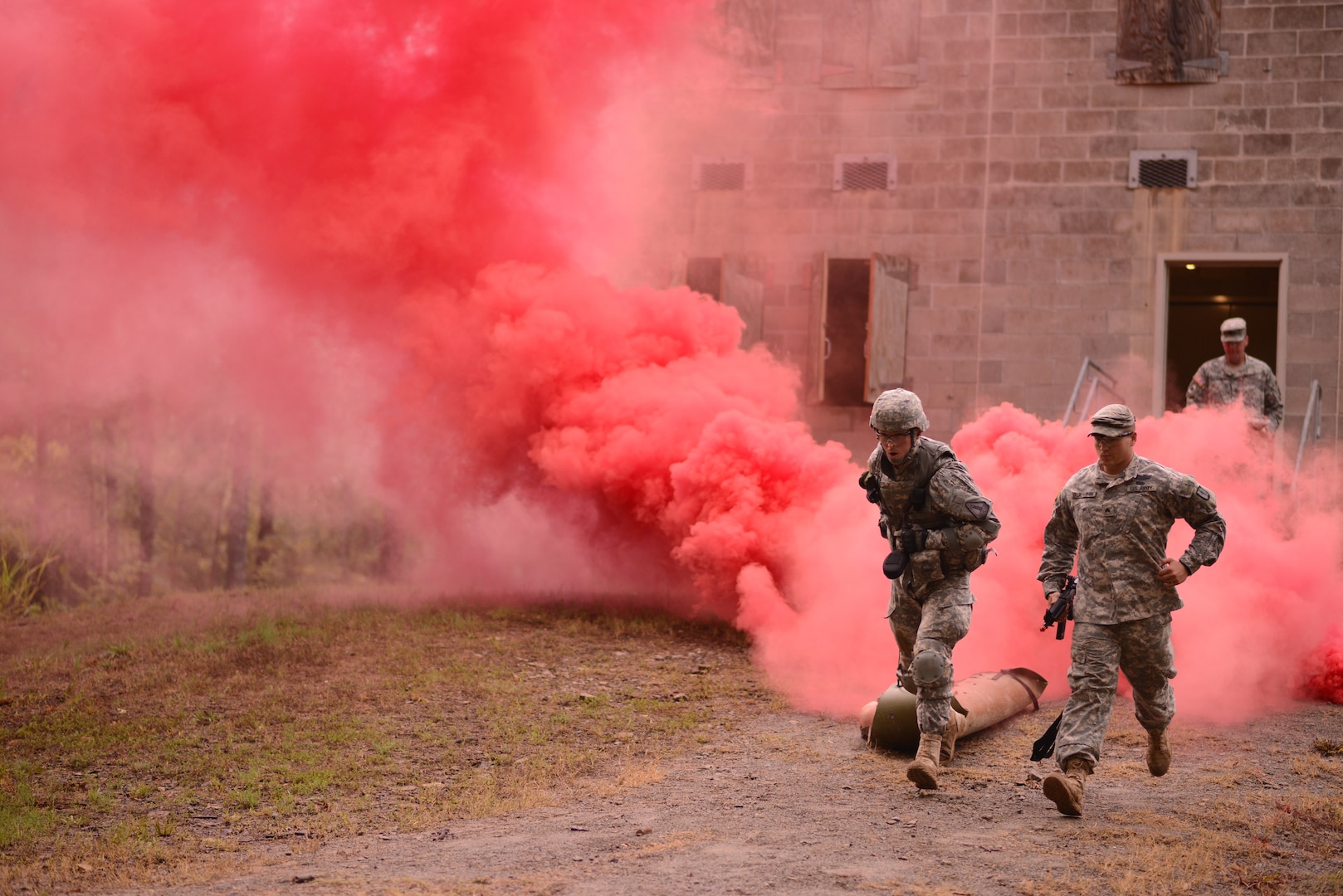 North Carolina Army National Guardsman with Detachment 4, Recruiting and Retention Battalion, Joint Force Headquarters, exits simulated shoot house, pulling litter with simulated casualty, as competitor in 2013 Army National Guard Best Warrior Competition, Little Rock Arkansas, July 23, 2013 (U.S. Army/Betty Boyce)