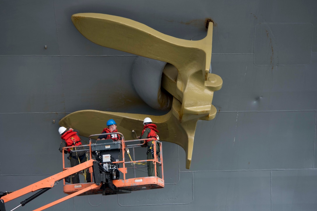 Servicemembers aboard USS Dwight D. Eisenhower paint starboard anchor gold, commemorating ship earning Retention Excellence Award for 2016,
Norfolk, Virginia, March 28, 2017 (U.S. Navy/Anderson W. Branch)