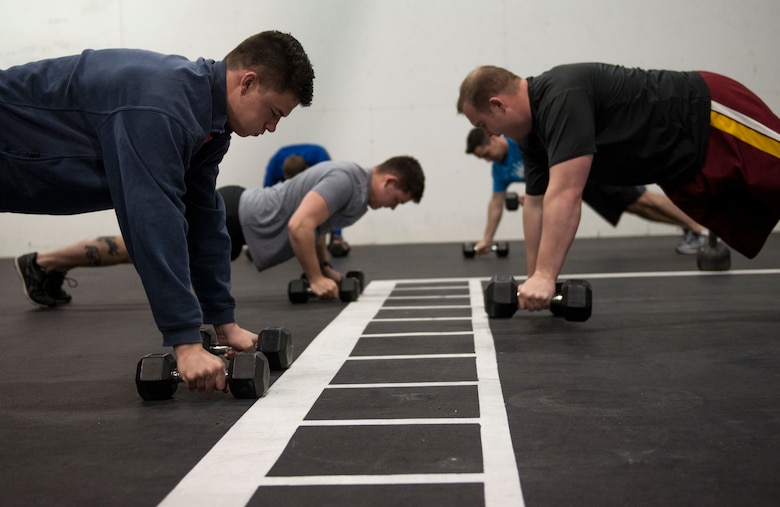 Initial Qualification Course student pilots assigned to the 310th Fighter Squadron perform a group exercise at Luke Air Force Base, Ariz., Feb. 6, 2018. Luke medical professionals from the Human Performance Team will use equipment like stationary bikes, row machines, and dumb bells to develop physical fitness solutions for the highly active work and lifestyles of Airmen. (U.S. Air Force photo by Airman 1st Class Alexander Cook)