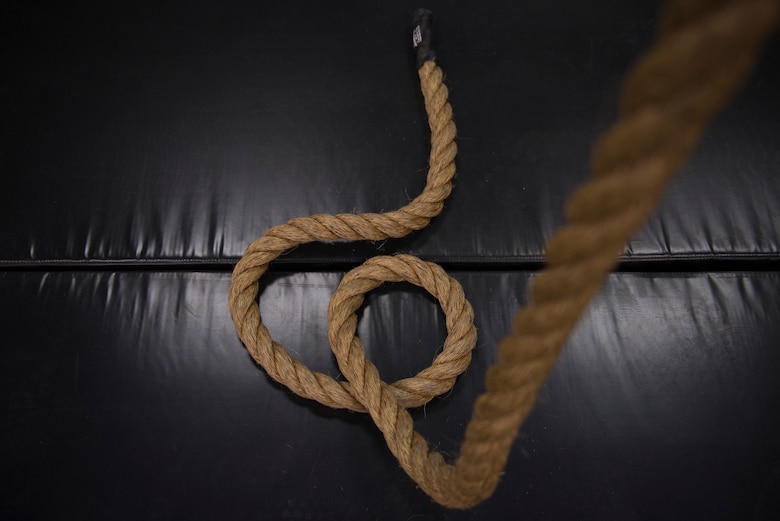 A rope dangles onto a mat at the Tactical Integrated Training and Nutrition Arena April 9, 2018, at Luke Air Force Base, Ariz. The TITAN Arena contains a variety of exercise utilities and fitness assessment tools. (U.S. Air Force photo by Senior Airman Ridge Shan)