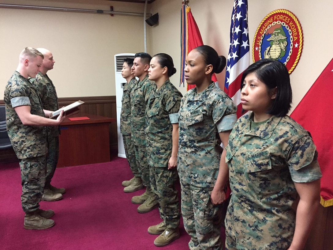Lt. Col. David M. Blankenship, U.S. Marine Corps Forces Korea G1 administration assistant chief of staff, presents a Marine Corps Administrative Analysis Team Certificate of Excellence to Chief Warrant Officer Vy N. Phan, MARFORK G1 personnel officer, during an award ceremony here, April 8.  (From left to right) Recognized for outstanding service in taking care of the Marines of MARFORK; Gunnery Sgt. Juan F. Gonzalez, MARFORK G1 administrative chief, received a Navy and Marine Corps Achievement Medal; Gunnery Sgt. Tiffany A. Freeman, MARFORK G1 adjutant chief, Staff Sgt. Andrene E. Castillo, MARFORK G1 personnel chief, and Sgt. Norma Azgomez, MARFORK G1 administrative clerk, received a Certificate of Commendation in addition to the MCAAT Certificate of Excellence for achieving the best MCAAT inspection score in the service for the past two years. (Official U.S. Marine Corps staff photo/Released)